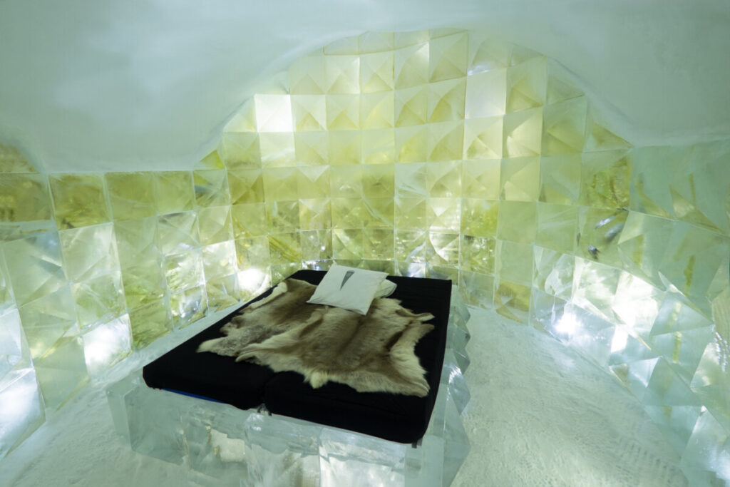 Bed and room interior of ICEHOTEL Sweden Room in Jukkasjarvi , Sweden