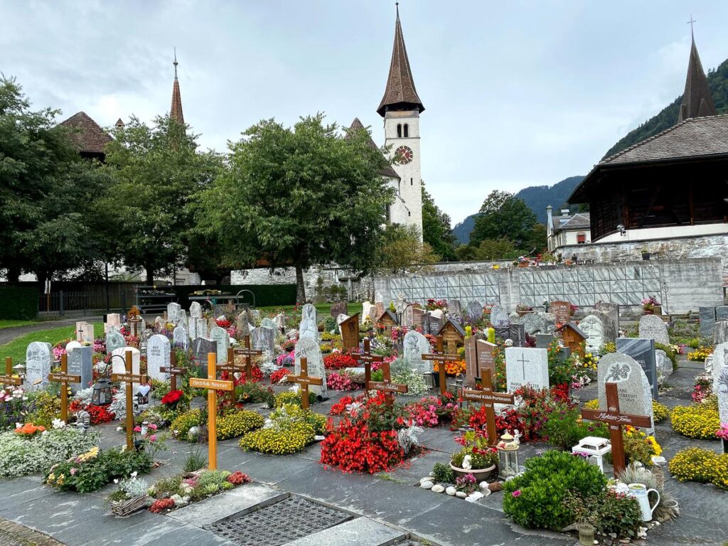 Interlaken Monastery and Cemetery with vibrant floral tributes