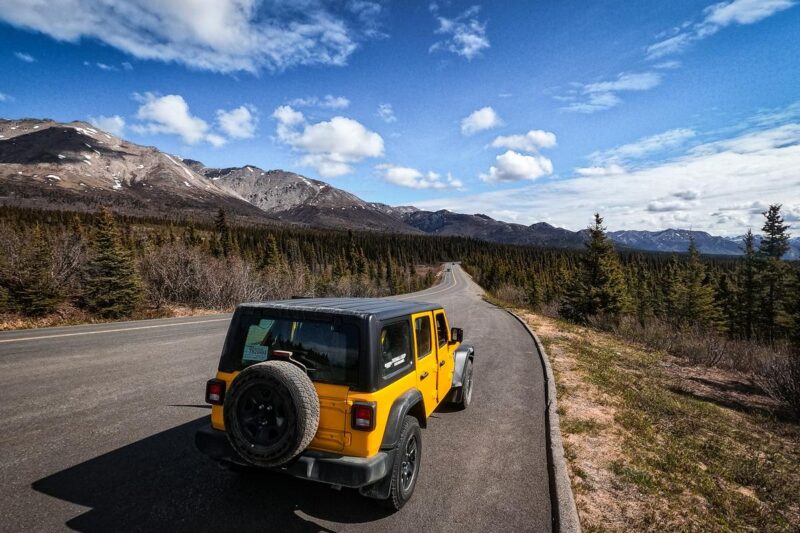 Yellow Jeep Wrangler on scenic Denali road, Alaska - Best jeep tours and reviews