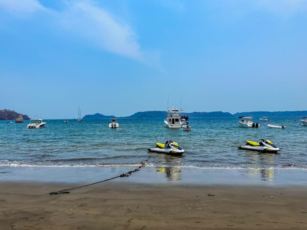 Jet skis ready for rental and boat excursions on Playa Panama, Costa Rica beach