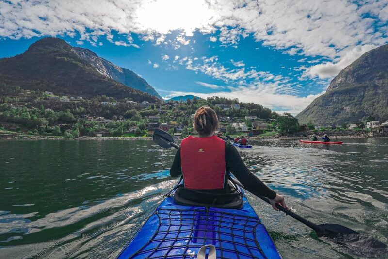 Kayaking in the fjords of Eidfjord, Norway with stunning mountains and serene waters