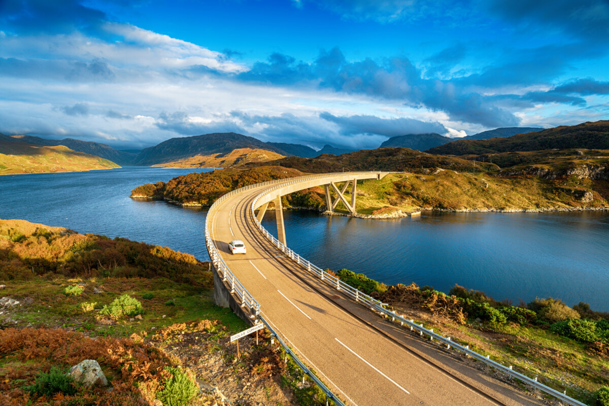 A car driving at the Kylesku Bridge in Scotland