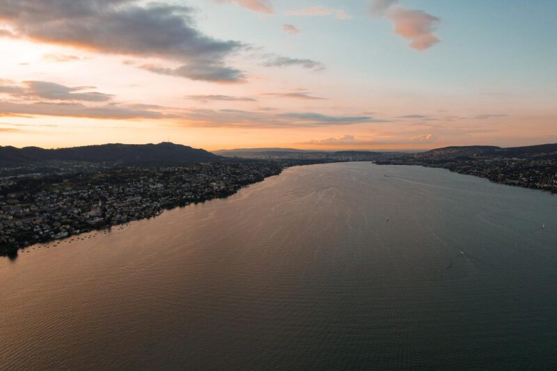 Stunning aerial sunset view of Lake Zurich with hills and scattered boats, zurich aerial view