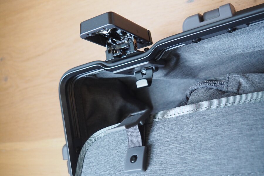 An open latch and the frame edge sit above the grey lining of the LEVEL8 Gibraltar suitcase.