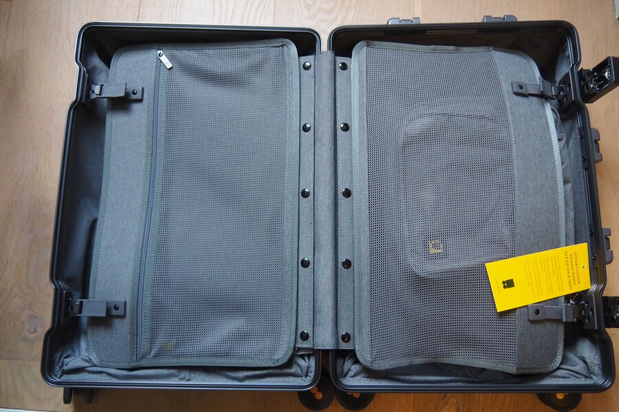 Open LEVEL8 Gibraltar carry-on with two mesh divider panels and a central metal hinge.