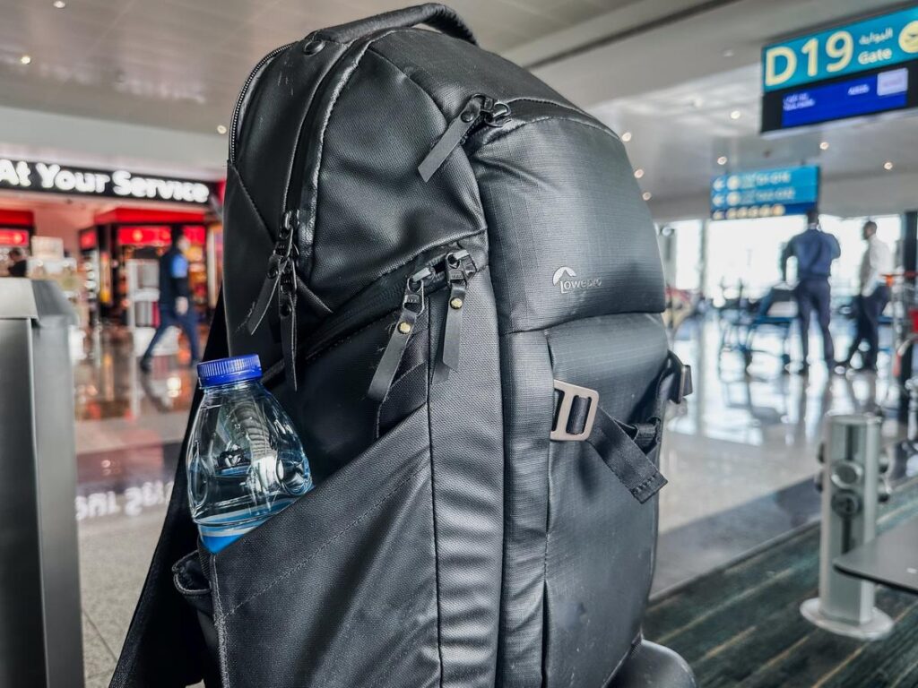 Durable Lowepro Freeline Backpack at airport gate D19 with water bottle in side pocket