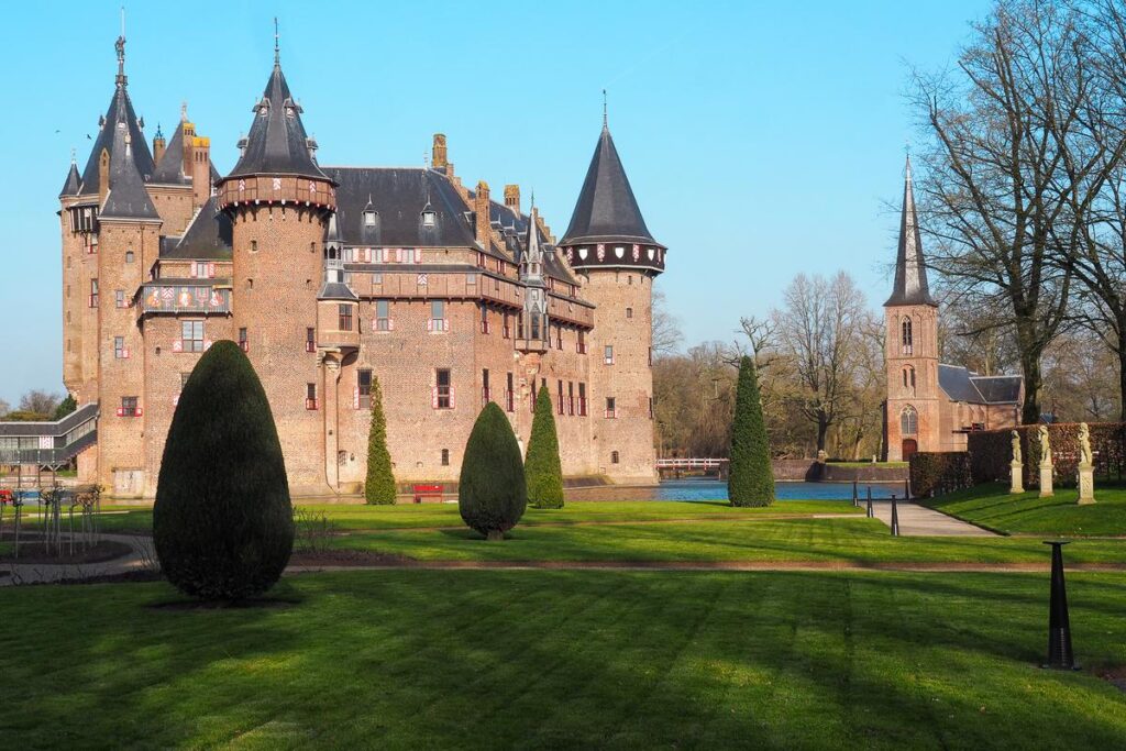 Castle De Haar in serene Dutch landscape, neo-Gothic architecture, gardens
