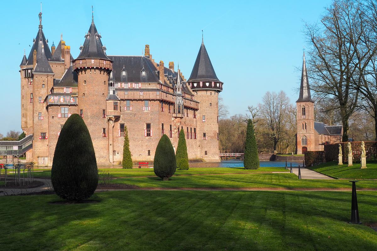 Castle De Haar in serene Dutch landscape, neo-Gothic architecture, gardens