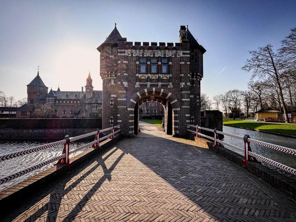 Majestic entrance to Castle de Haar, a historical Dutch landmark with ornate gatehouse and moat