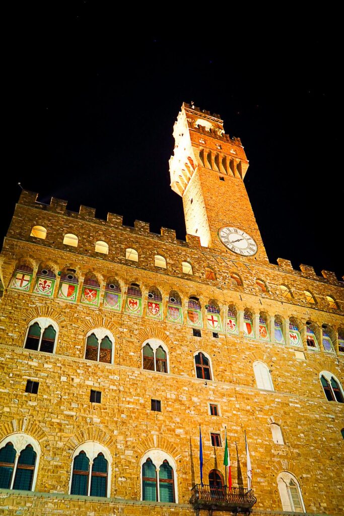 Night-time view of illuminated Palazzo Vecchio Clock Tower in Florence, Italy