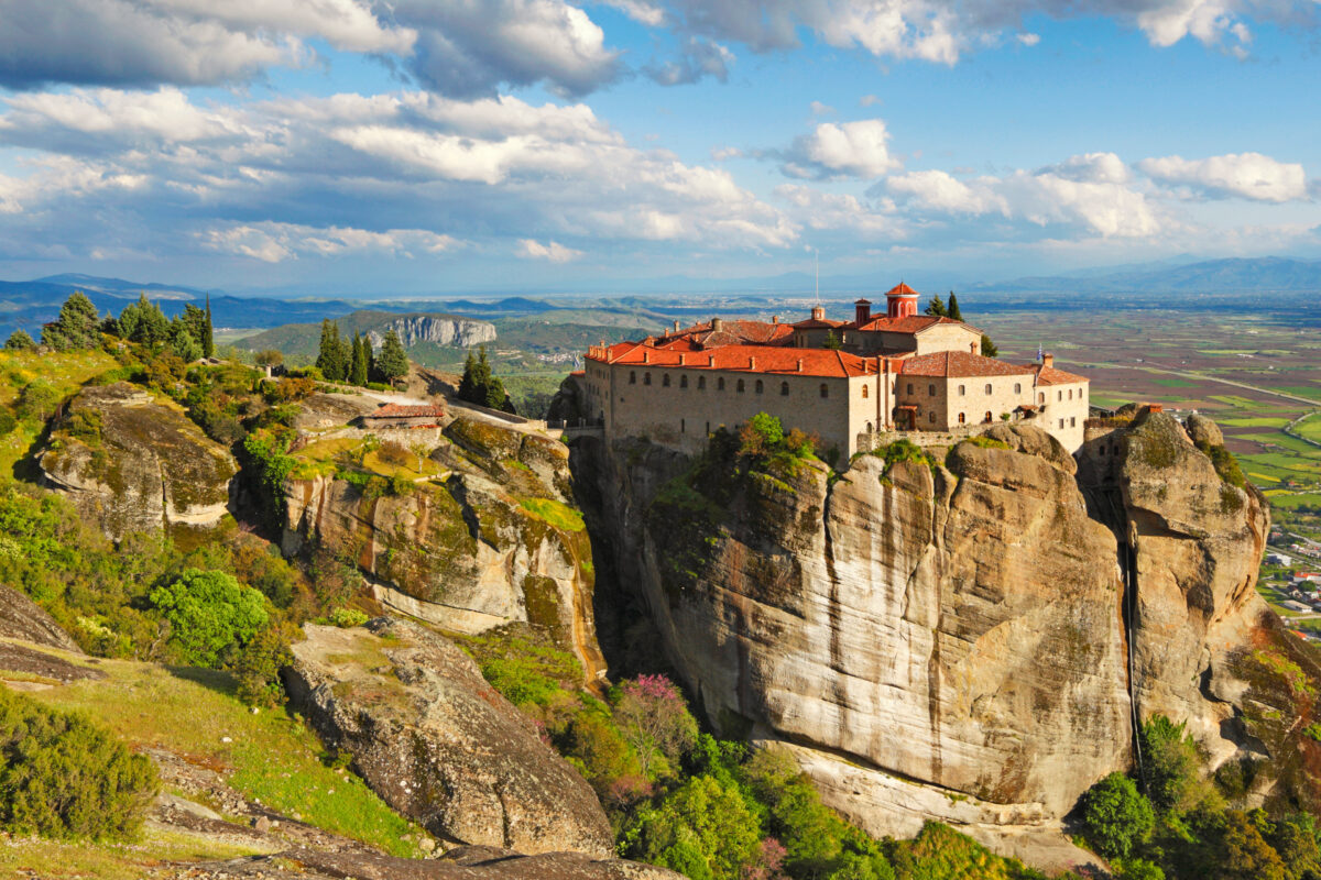 Agios Stephanos Monastery, Meteora, Greece, a cliffside Orthodox monastery with red-tiled roofs and bell tower.