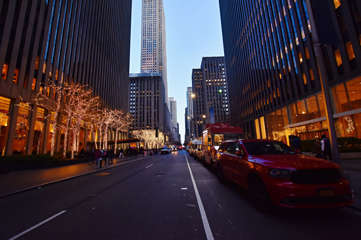 Night street view and city life on Sixth Avenue or Avenue of the Americas, Midtown Manhattan, New York.