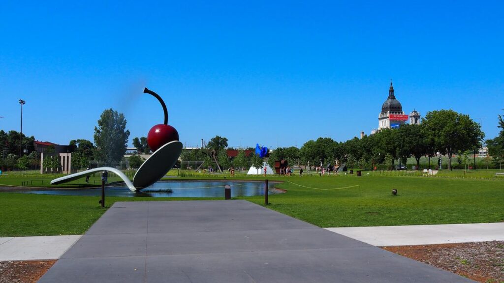 Minneapolis Sculpture Garden featuring the iconic Spoonbridge and Cherry sculpture, contemporary art, and city skyline.