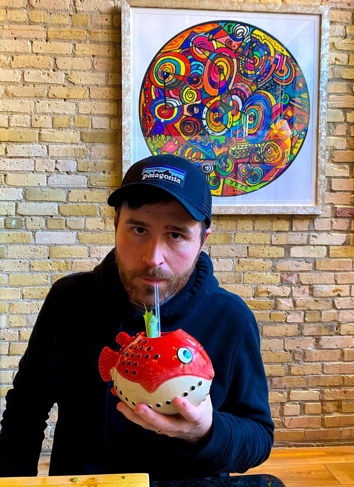 Kyle Kroeger enjoying fish-shaped cocktail at Billy's Sushi Minneapolis