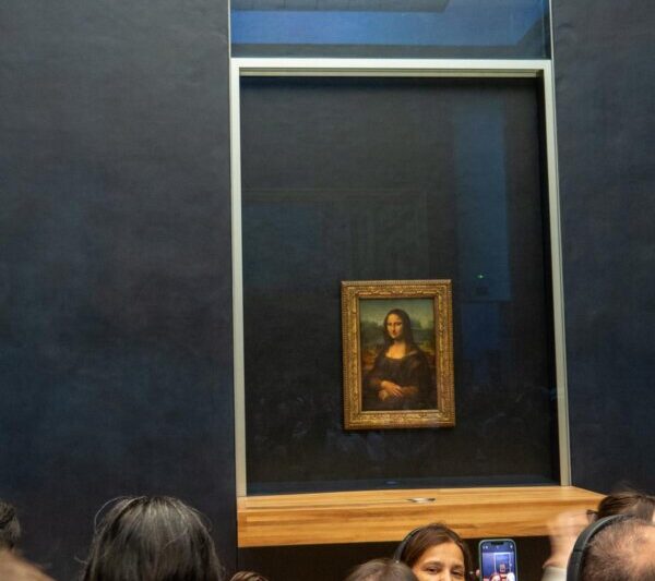 Visitors admiring Mona Lisa in the Louvre Museum, Paris