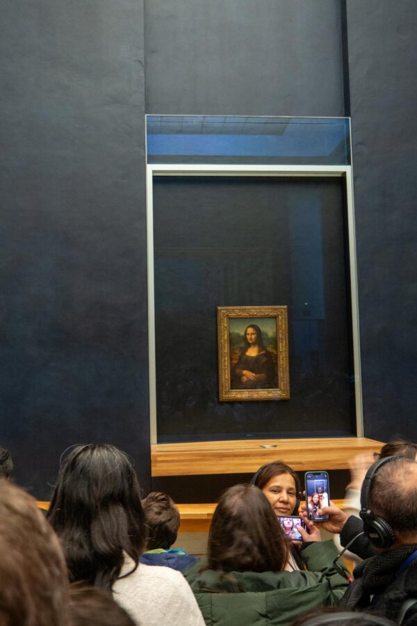 Visitors admiring Mona Lisa in the Louvre Museum, Paris