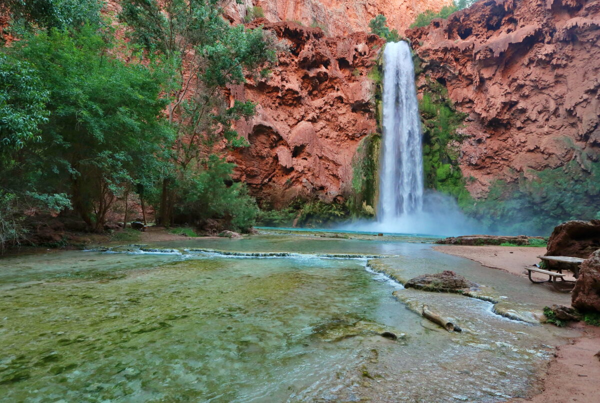 Mooney Falls, Havasupai, Grand Canyon, features waterfall, teal pools, and red canyon walls.