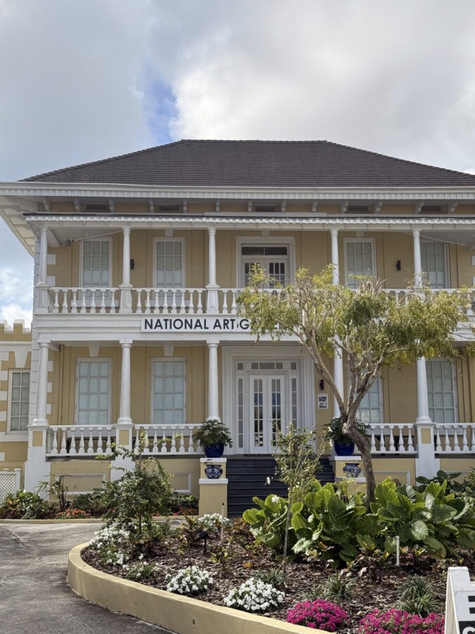 Yellow colonial Villa Doyle mansion housing the National Art Gallery of The Bahamas in Nassau, with tropical gardens