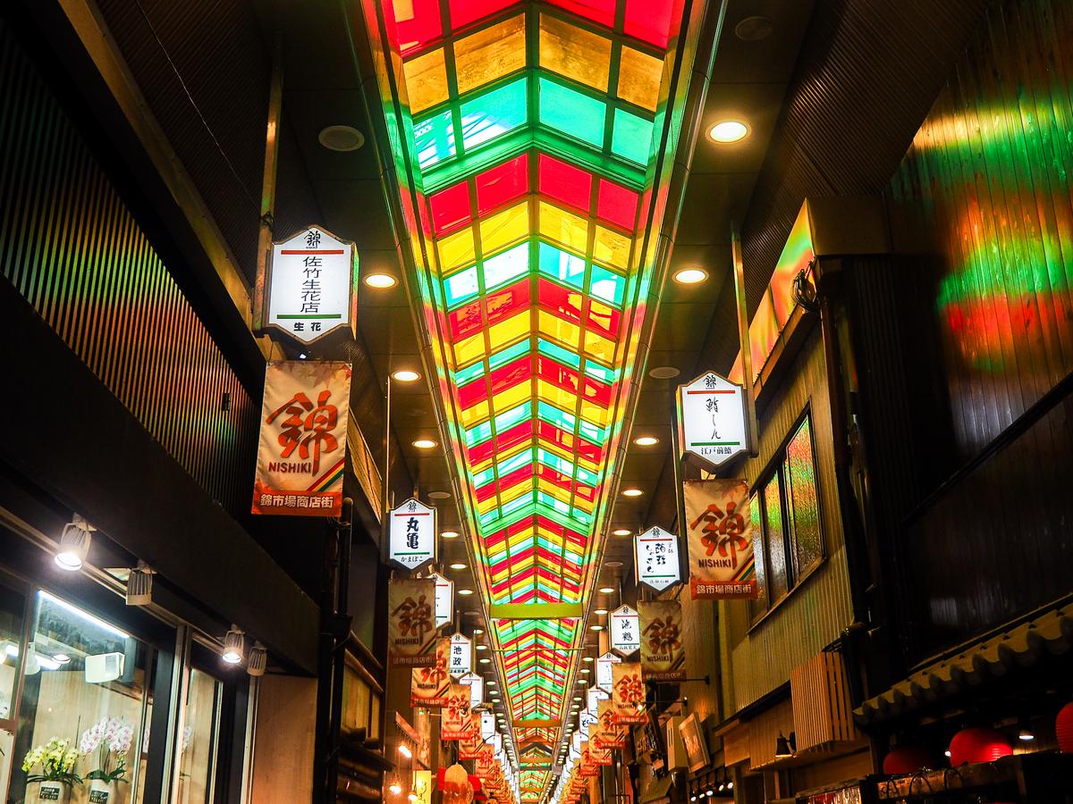 Colorful Nishiki Market in Kyoto with vibrant food stalls and traditional lanterns