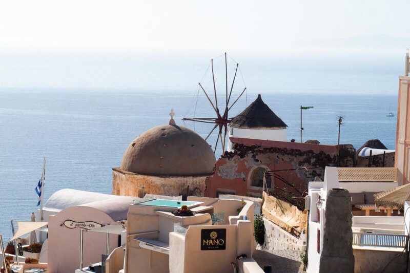 Sunset over Oia Santorini, iconic white-washed architecture and Aegean Sea views