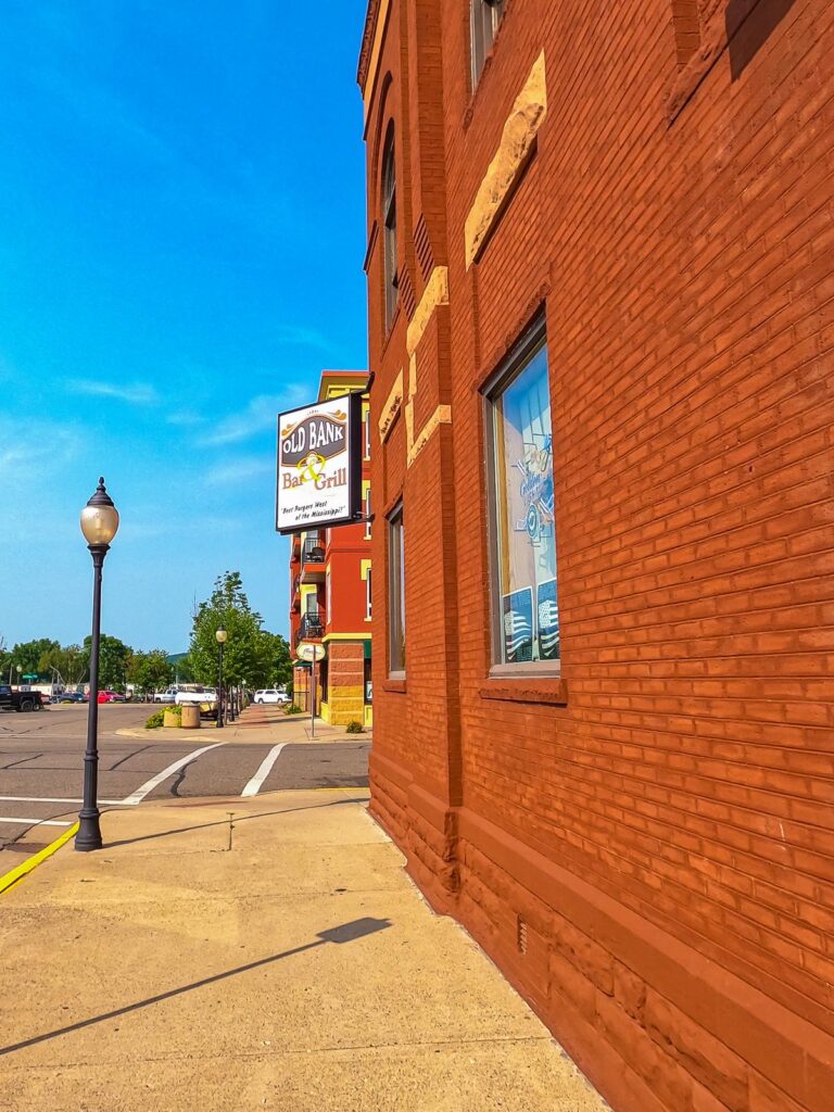 Old Bank Bar & Grill, Lake City - Terracotta-hued brick facade, inviting eatery, and sidewalk view