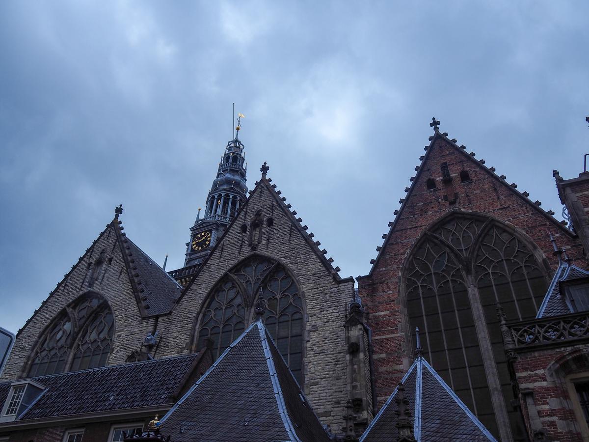 Oude Kerk steeple under a moody sky in Amsterdam