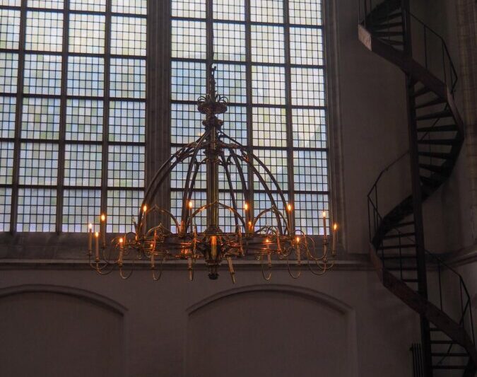 Ornate chandelier and spiral staircase in Oude Kerk Amsterdam