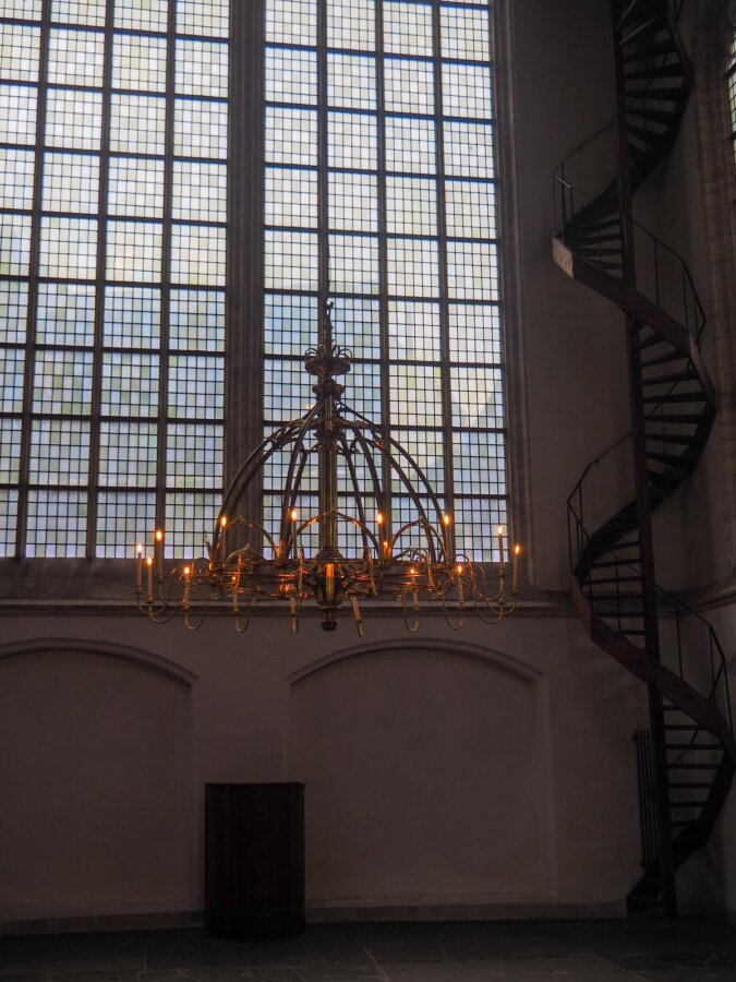 Ornate chandelier and spiral staircase in Oude Kerk Amsterdam