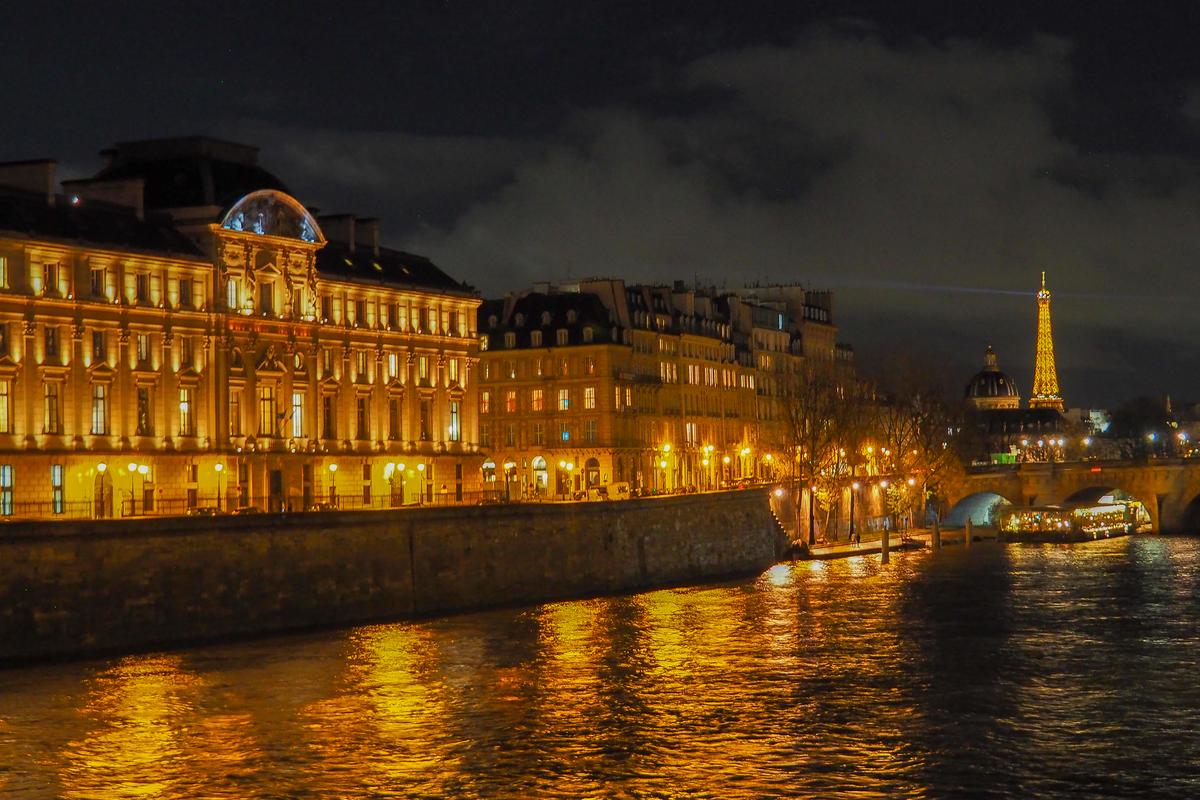 Eiffel Tower and Seine River illumination at night in Paris