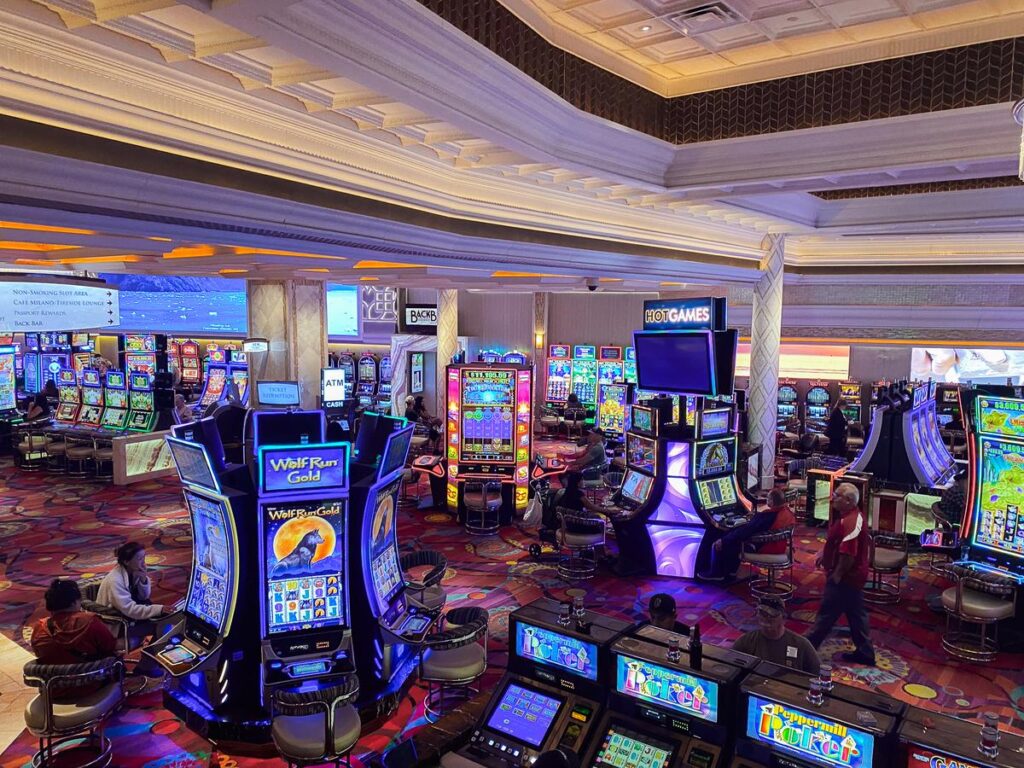 View of Peppermill Reno Resort’s vibrant casino floor with guests, slot machines, and rich interior design.