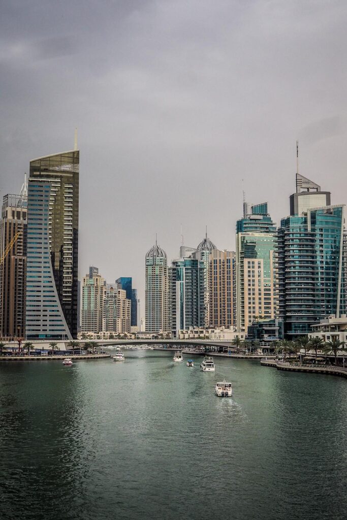 Panoramic view of Dubai Marina with skyscrapers and leisure boats, reflecting cosmopolitan lifestyle.