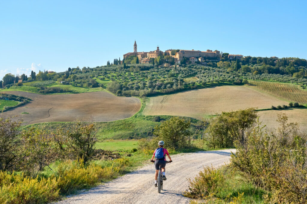  A tourist biking in the Ghianti area of Pienza, Italy