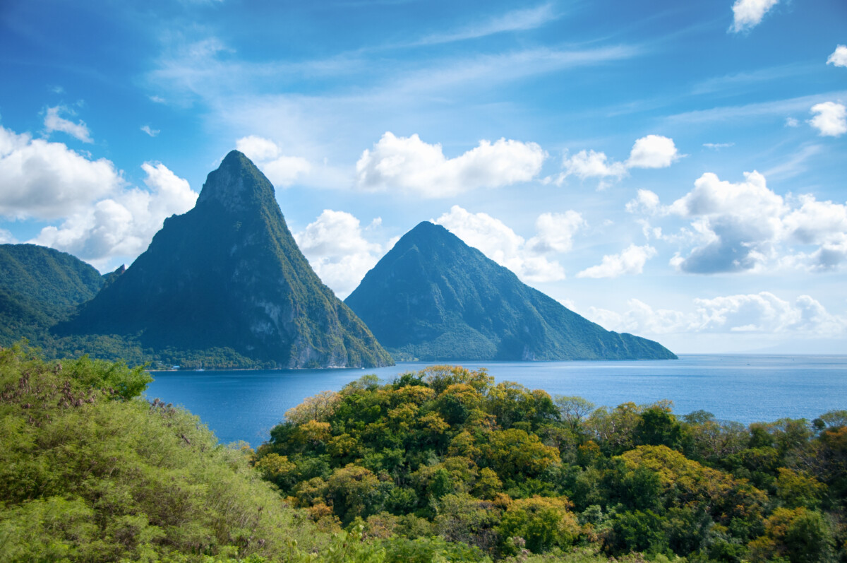 Pitons in St Lucia with water in foreground. St.Lucia is one of the best places like hawaii for travelers, with mountains and tropical scenery.