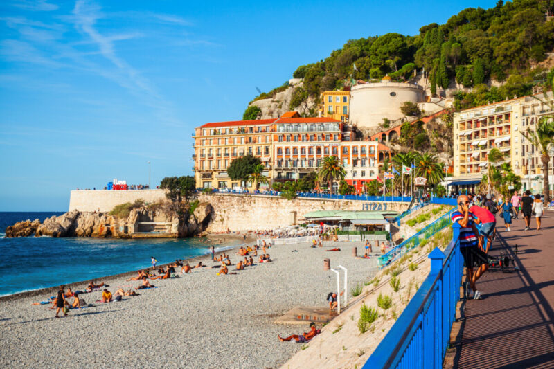 Tourists relaxing in Plage Blue Beach, Nice, France