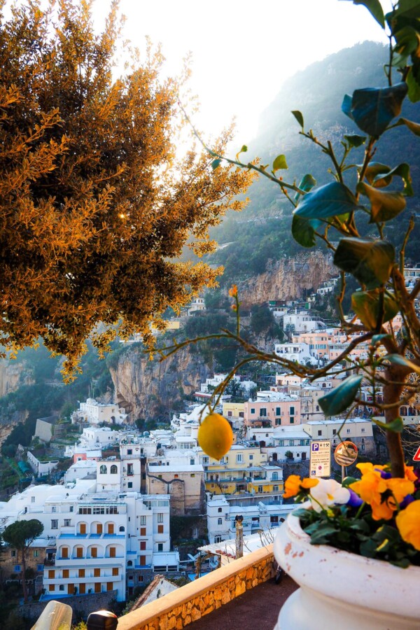 Hotel Villa Gabrisa view of Positano hillside with lemon tree, sunset hues, and Mediterranean architecture.