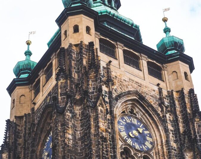 St. Vitus Cathedral's Gothic exterior with green spires in Prague