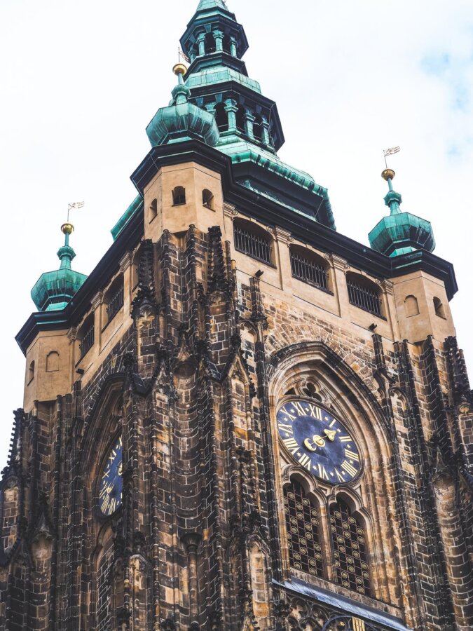 St. Vitus Cathedral's Gothic exterior with green spires in Prague