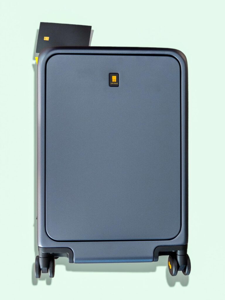 Premium navy blue hardshell spinner luggage with TSA lock and Level8 branding on mint green background