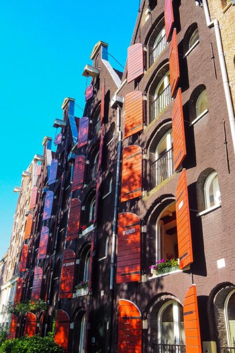 Picturesque Prinseneiland canal houses in Amsterdam with iconic hooks and vibrant shutters