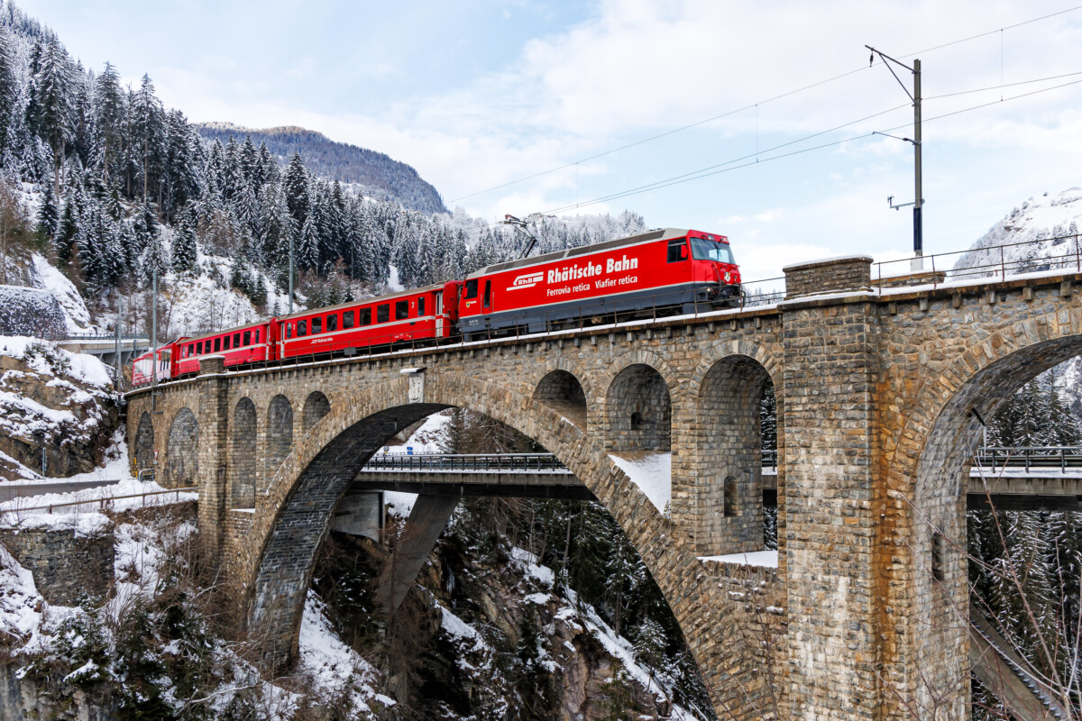 Rhaetian Railway train passing by the Soliser Viaduct on Albula line in Solis, Switzerland Swiss Alps