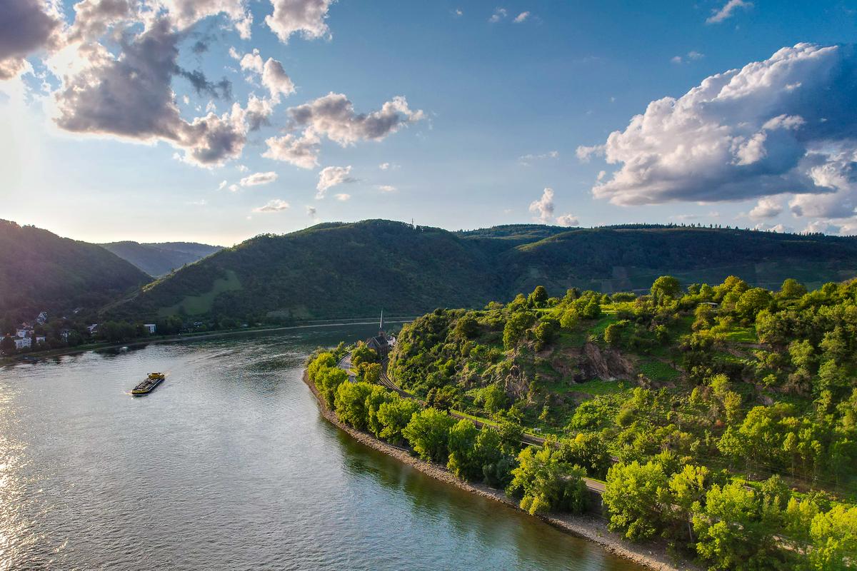 Sunset over Upper Middle Rhine Valley with barge