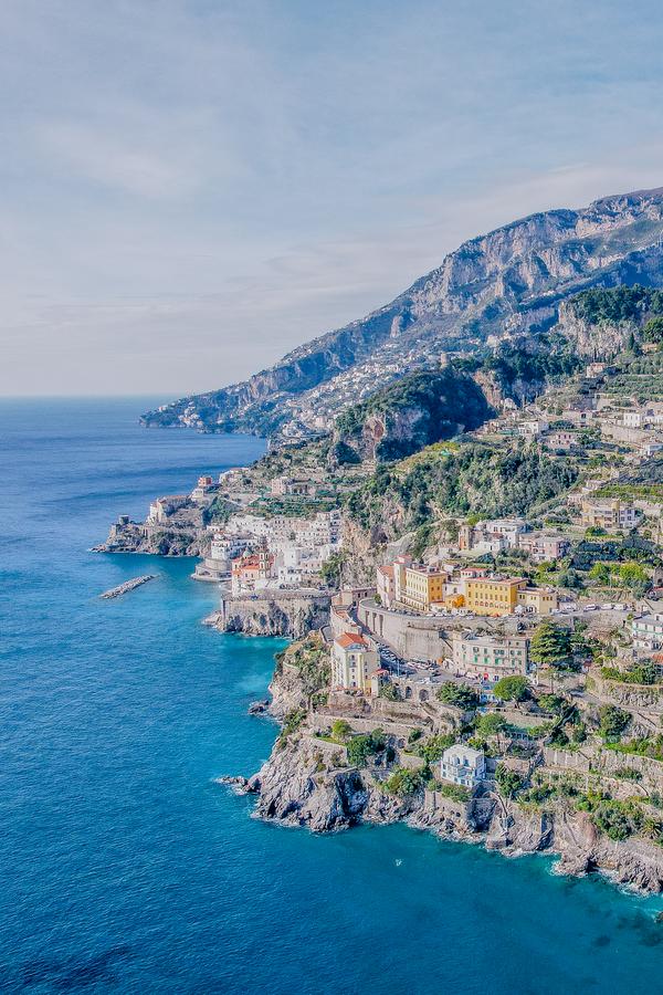 Breathtaking aerial view of Amalfi Coast's rocky shores and colorful cliffside villages