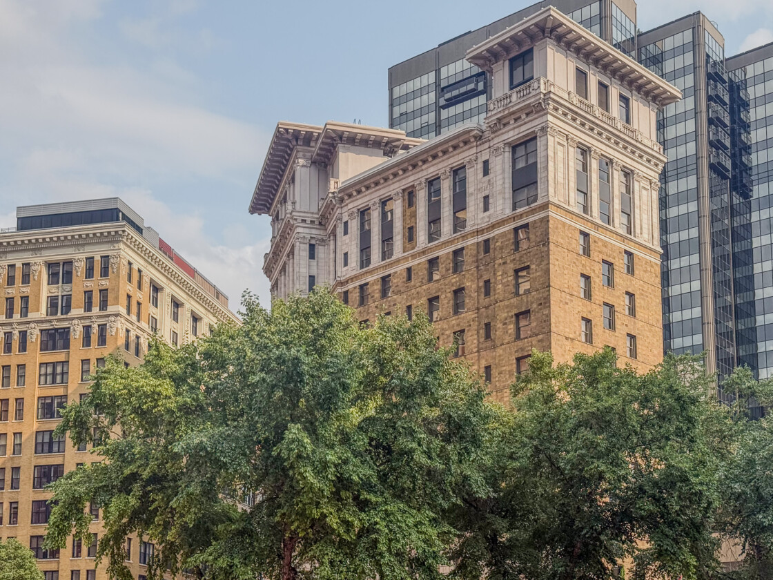Saint Paul Hotel in downtown Saint Paul, Minnesota, framed by trees and historic architecture.
