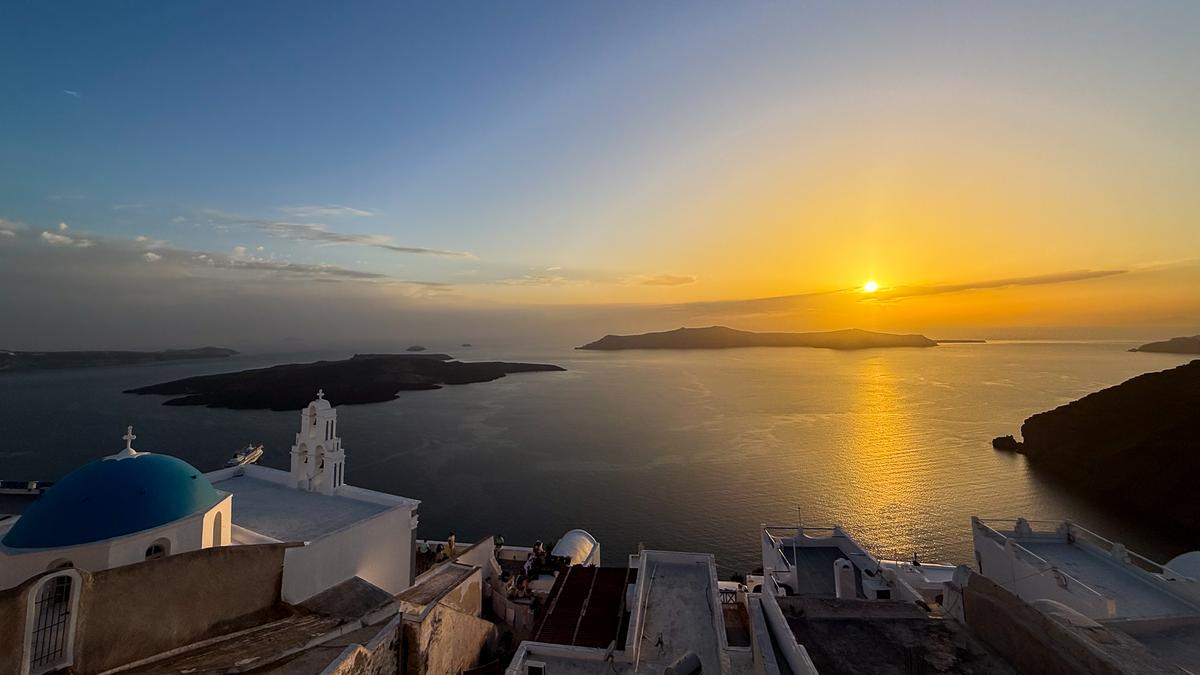 Sunset over Three Bells of Santorini, Greece, with Aegean sea views