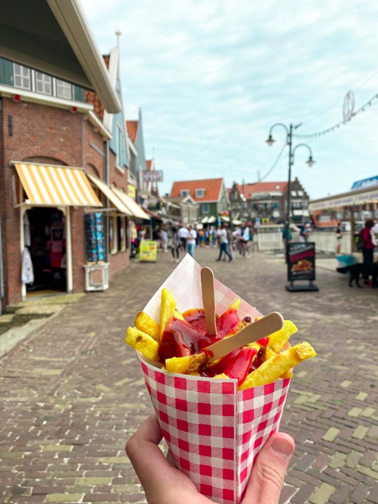 Golden Dutch fries in Volendam, Netherlands, against picturesque streets