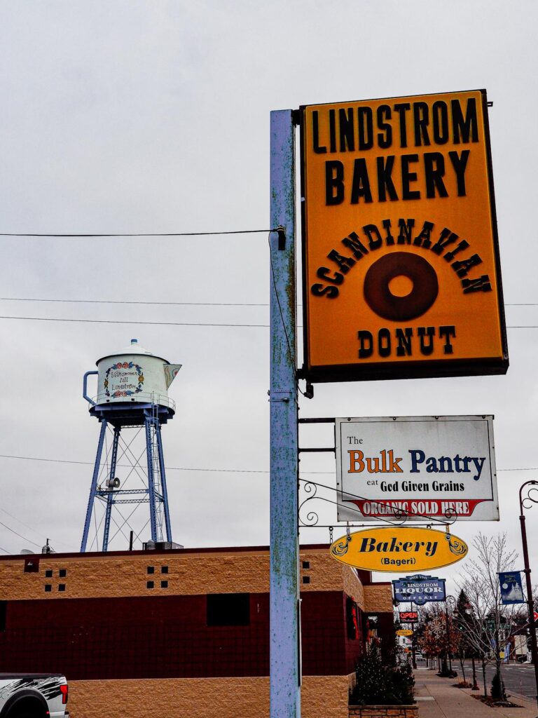 Scandinavian donut at Lindstrom Bakery, MN, with vintage signage, water tower, and local, organic treats.