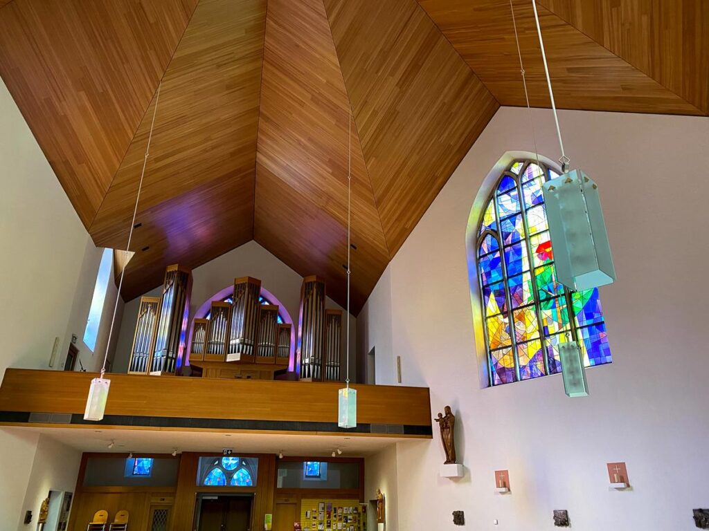 Serene Schloss Interlaken Monastery interior with organ pipes and stained glass.