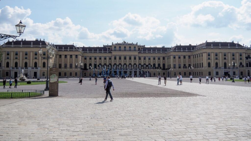 Schönbrunn Palace exterior with tourists, Vienna.