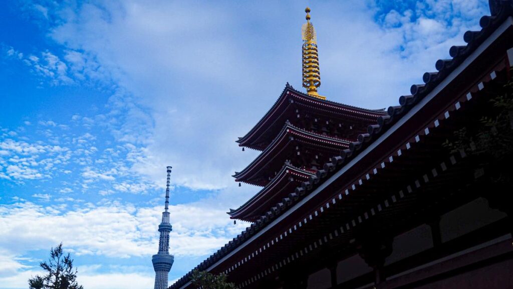 Sensō-ji Temple's pagoda and Tokyo Skytree against a dynamic sky, showcasing Tokyo's blend of tradition and modernity.