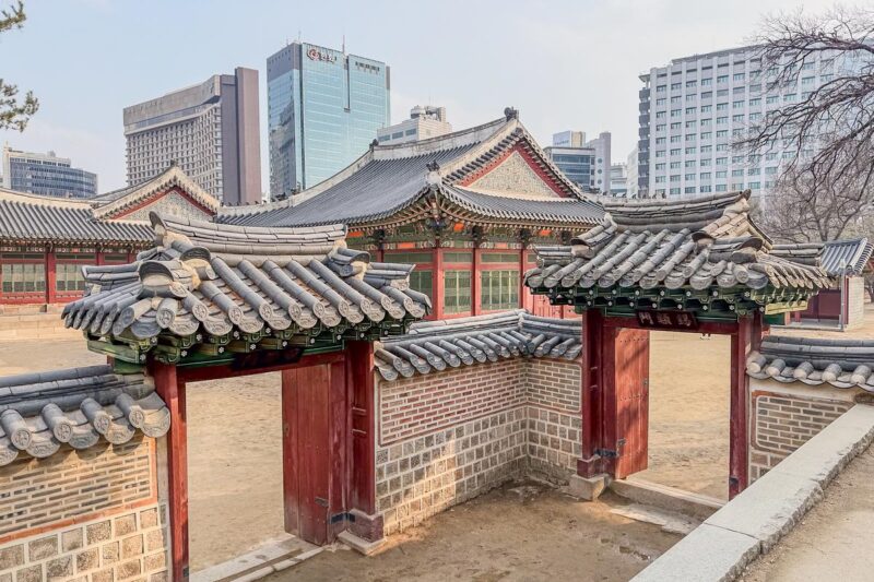 Seoul palace with city skyline at sunset, iconic Korea travel destination